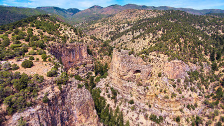 Rocky mountain canyon with desert and green shrubsの写真素材
