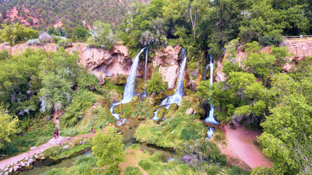 Natural triple waterfall in forest over cliffsの写真素材