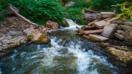 Hidden waterfalls tucked into abandoned area of cement blocksの写真素材