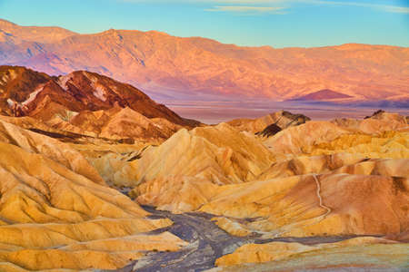 Death Valley stunning sunrise colors in sediment layers of mountainsの写真素材