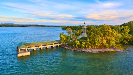 Fall coastline aerial next to large dock and cement memorial lighthouse tower