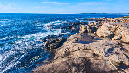 Rocky coasts of Maine with ocean waves crashing into cliffsの写真素材