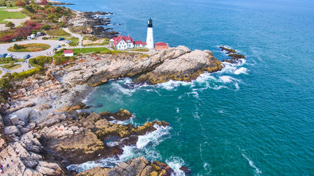 Wide panorama aerial over Portland Head lighthouse with rocky coastの写真素材