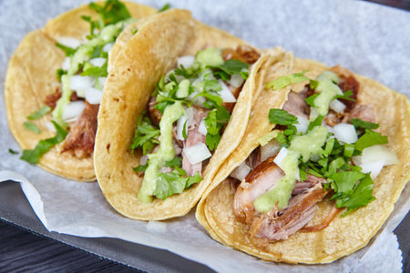 Carne Asada Mexican street tacos white onion cilantro corn tortillas white paper black trayの写真素材