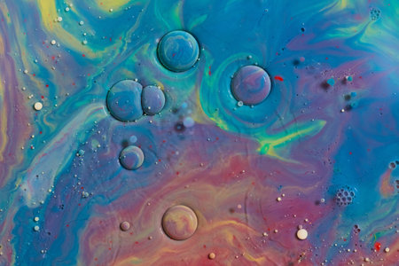 Colorful blue, gold, purple, green, yellow swirling in abstract cosmic space art background assetの写真素材