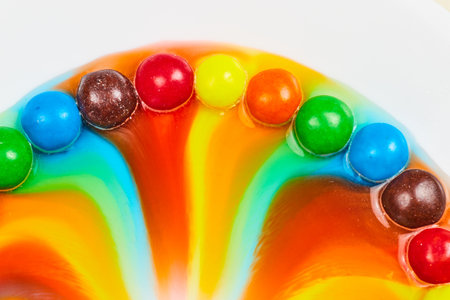 Hill of candy skittles with mound of colors raining downの写真素材