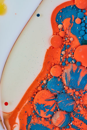 Milky sea of oil and acrylic paint in abstract background painting with bubbles and poured paint