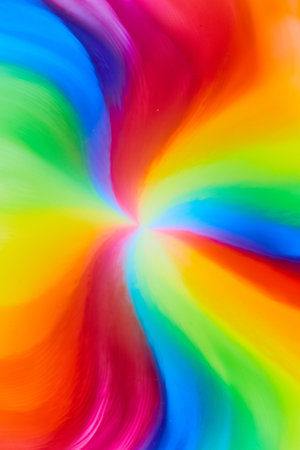 Vertical of rainbow tie die colors from skittles water and color as candy and sugar dies create psychedelic hippie backgroundの写真素材