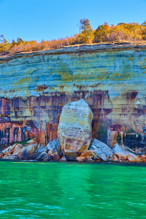 Cliff face with bleeding colors of Pictured Rocks at National Parkの写真素材