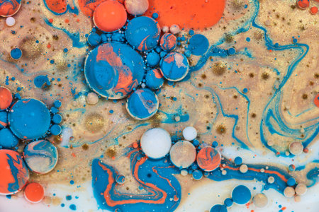 Spheres of cosmic eruption in sea of milk and oil and acrylic paint in abstract background assetの写真素材