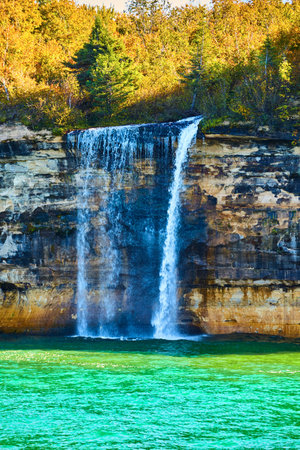 Waterfall at Pictured Rocks cascading into turquoise waters in Lake Superiorの写真素材