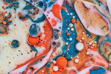White milk with abstract pearls of white orange and blue bubbles in background assetの写真素材