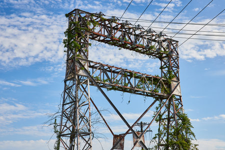 Power, electrical tower power lines, wires, abandoned, decaying, ivy covered, blue sky