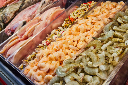 Meat department, seafood mix, raw shrimp, cooked shrimp, tilapia filet, catfish uncooked fishの写真素材
