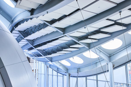 Pristine white architecture with unique lighting and interior ceiling tiles abstract viewの写真素材