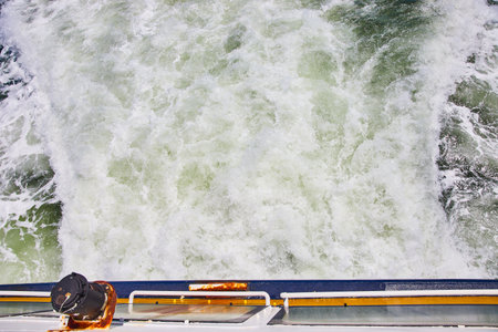 Stern of ship with very choppy white wake waterの写真素材
