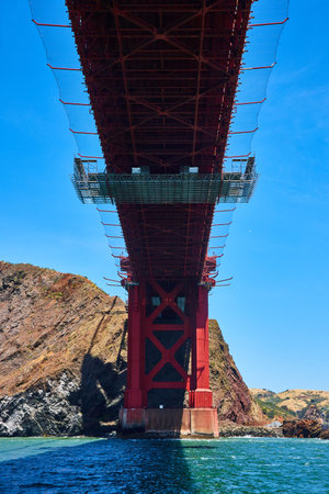 Underside view of Golden Gate Bridge with choppy San Francisco Bay waters
