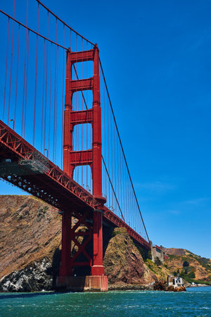 Underside and side view of Golden Gate Bridge with clear blue skies on bright summer dayの写真素材