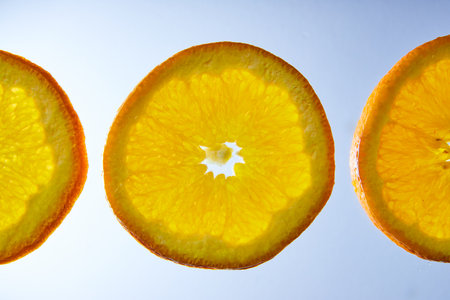 Macro three orange slices on white backgroundの写真素材