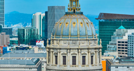 Aerial zoomed in view of city hall dome roof with skyscraper buildings in background