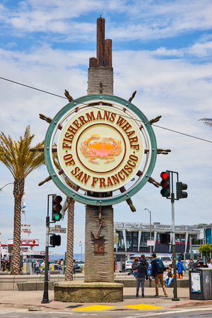 Fishermans Wharf of San Fransisco sign with crab on it with pedestrians walkingの写真素材