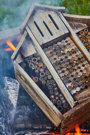 Smoke flowing through burning wooden beehive with smoke and ashesの写真素材
