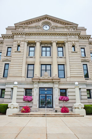 Entrance to Auburn courthouse with flowers on windowsill and beside steps leading to doorsの写真素材