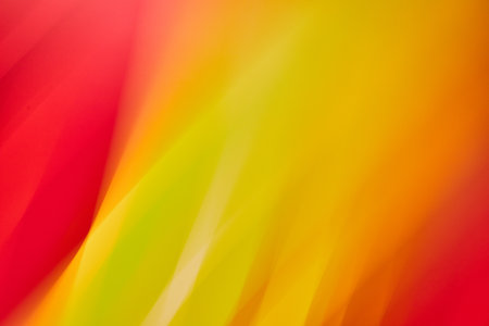 Abstract yellow flame ending in orange and framed by red on two corners abstract background assetの写真素材