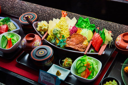 Seafood and meat sushi boat Osakaya Special made with toy food items on displayの写真素材