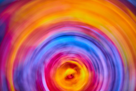 Abstract sunrise with tie dye rainbow swirl of color in artistic blurの写真素材