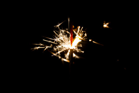 Luminous Sparkler in Motion Against Pitch-Black Background