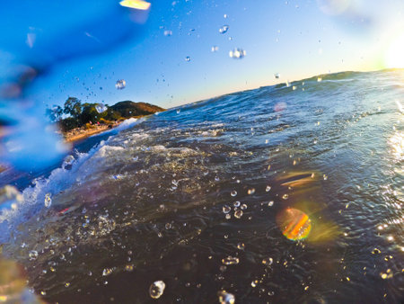 Golden Hour Waves at Lake Michigan Beach splash onto lensの写真素材