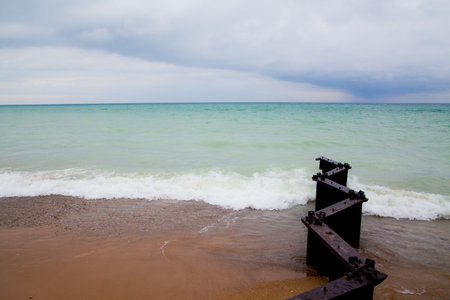 Overcast Day at Lake Michigan with Weathered Pier Remnantsの写真素材