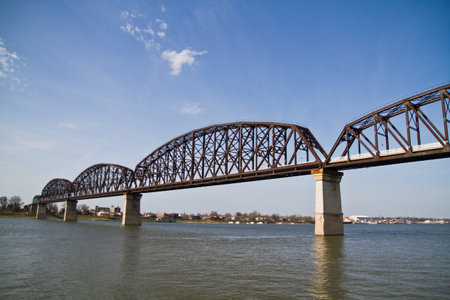 Serene View of Industrial Metal Truss Railroad Bridge Over River in Louisvilleの写真素材