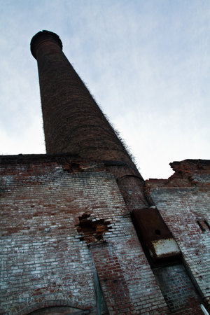 Abandoned Industrial Brick Chimney Overgrown with Vines in Louisvilleの写真素材