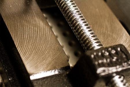 Close Up of Shiny Threaded Screw in Sturdy Metal Vice Gripの写真素材