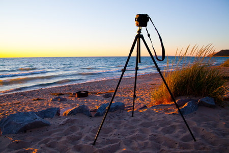 Golden Hour Beach Scene with Pro Camera on Tripod, Lake Michigan Low Perspectiveの写真素材