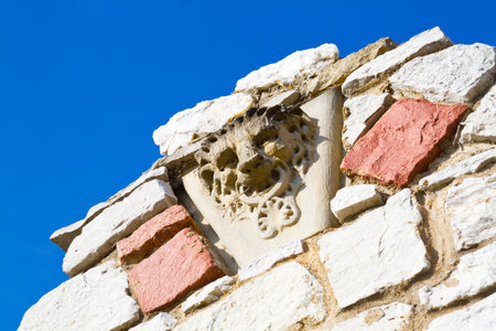 Sunlit Medieval Stone Carving against Blue Sky in St. Louis, Missouriの写真素材