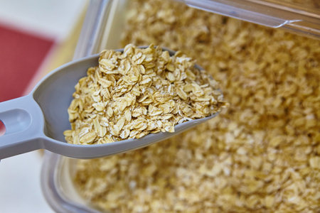 Scooping Bulk Oats in Health Food Store, Close-Up Perspectiveの写真素材