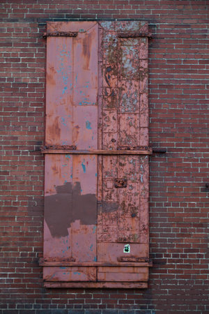Decaying Red Door in Urban Brick Wall, Louisvilleの写真素材