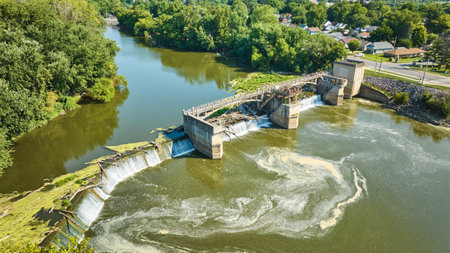 Maumee River Dam swirling water with waterfalls chocked by tree logs aerial of river Fort Wayne, INの写真素材