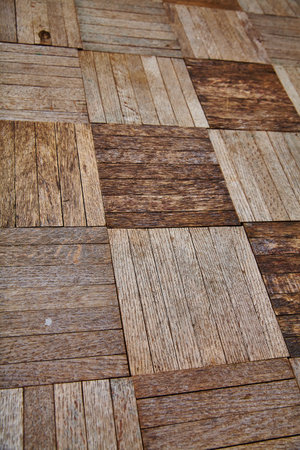 View of Rustic Herringbone Wood Flooring Texture in Warm Tones Close-Up