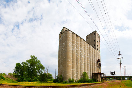 Abandoned Industrial Silo and Power Lines in Illinois Landscapeの写真素材
