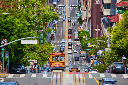 Two Van Ness Avenue streetcars after passing one another on hill, San Francisco, CAの写真素材