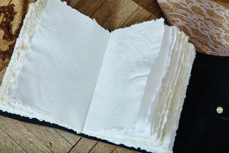 Handcrafted Paper Album with Burlap and Lace on Woodの写真素材