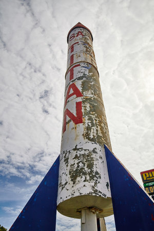 Vintage Saturn Rocket Structure with Blue Fins against Cloudy Skyの写真素材