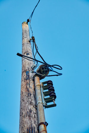 Aged Utility Pole and Power Lines Against Blue Sky, Ohioの写真素材