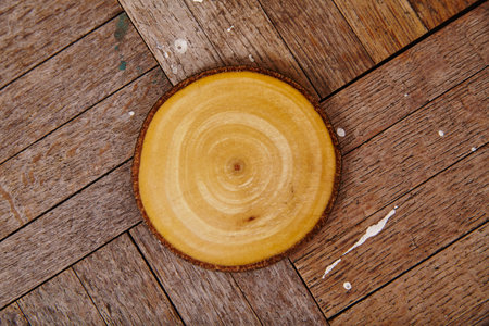 Rustic Wooden Slice with Tree Rings on Weathered Planks, Top Viewの写真素材