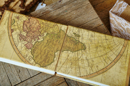 Vintage Map Book on Wooden Table with Rustic Charm