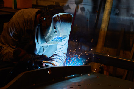 Skilled Welder at Work with Intense Sparks, Industrial Setting Close-Up